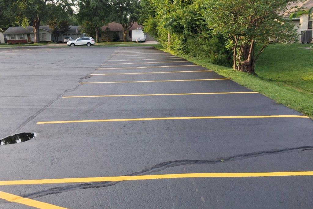 Hot crack sealing and fresh striping on a commercial parking lot by Reliable Pro Seal