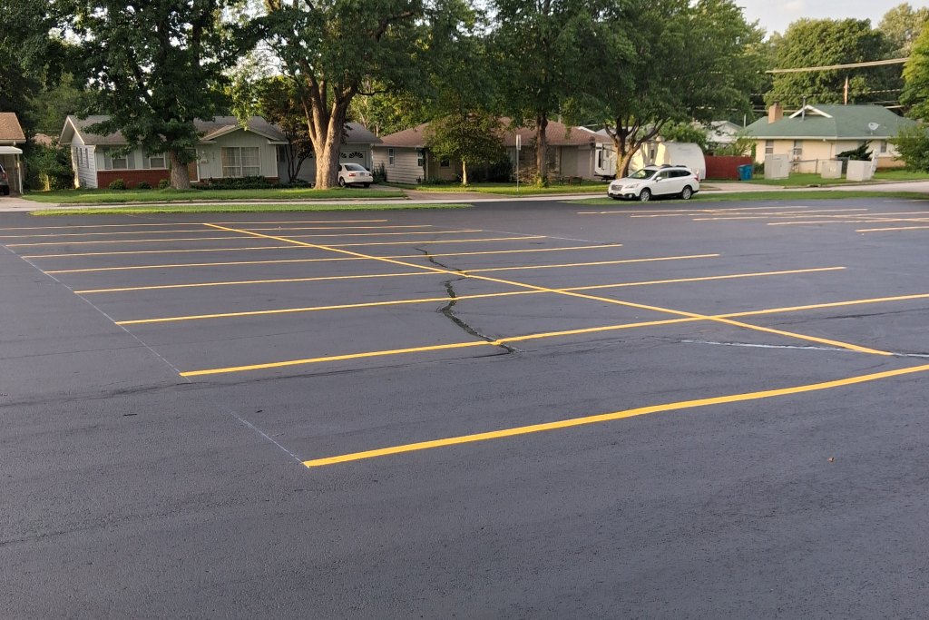 Freshly sealcoated and striped commercial parking lot by Reliable Pro Seal in Springfield, MO